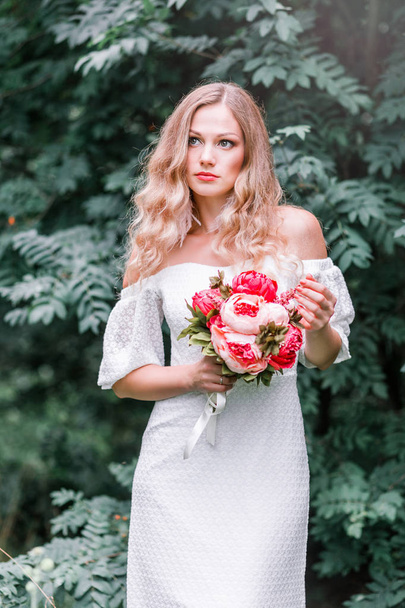 Bride with a bouquet of peonies in her hands - Photo, Image