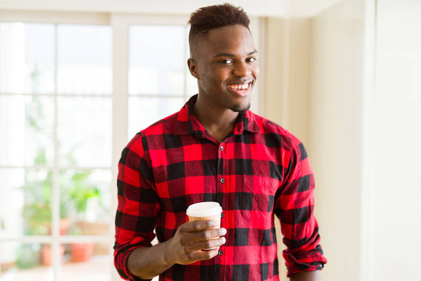 African american man smiling confident drinking a coffee in a take away paper cup - Photo, Image