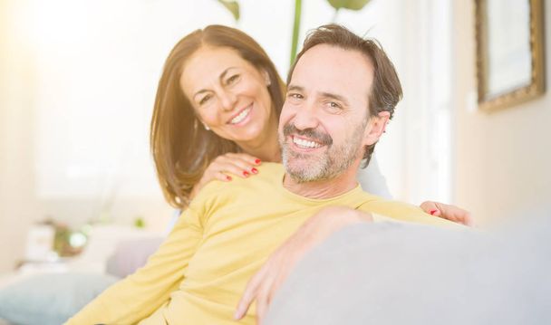 Middle age romantic couple sitting on the sofa at home - Photo, image