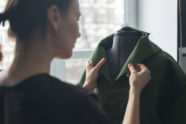 Tailor taking measurements for sewing suit at tailors shop. Custom Made Cloth Concept. - Fotó, kép
