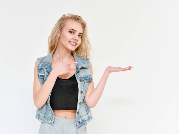Photo of blond female model with white teeth looking at camera and smiling. Isolated on a white background - 写真・画像