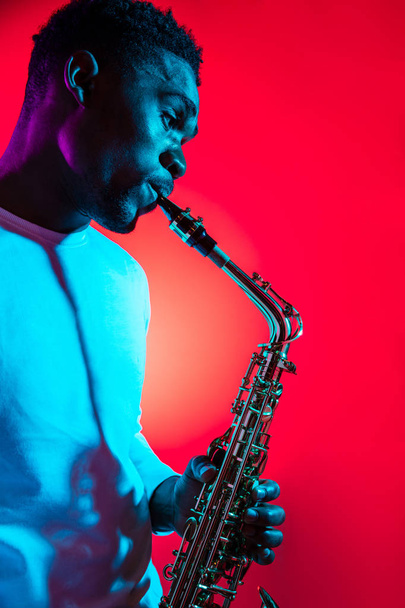 African American jazz musician playing the saxophone. - Valokuva, kuva