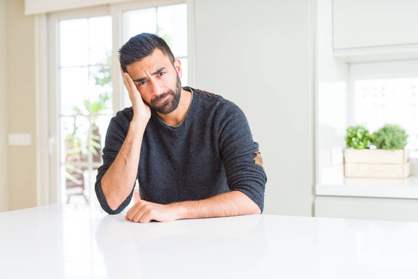 Handsome hispanic man wearing casual sweater at home thinking looking tired and bored with depression problems with crossed arms. - Photo, Image