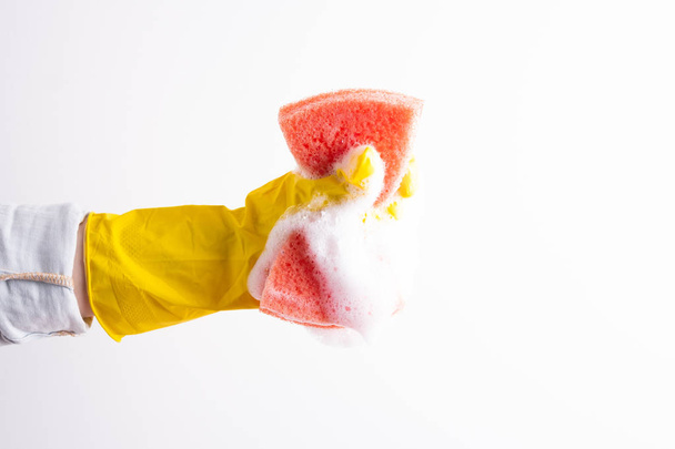 Hand squeezes out a sponge on a white background - Fotoğraf, Görsel