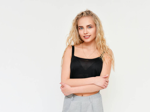 Photo of blond female model with white teeth looking at camera and smiling. Isolated on a white background - Photo, image