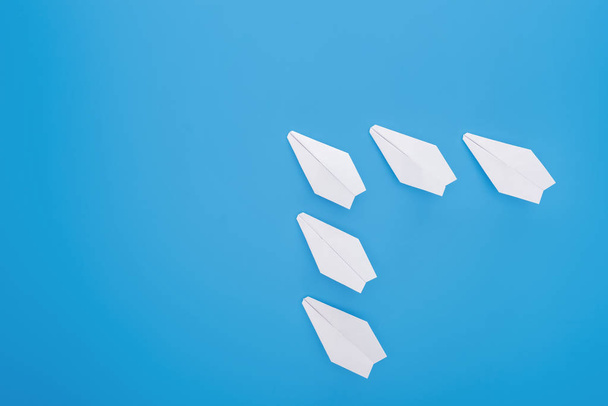 Flat lay with white paper planes on blue surface - Photo, image