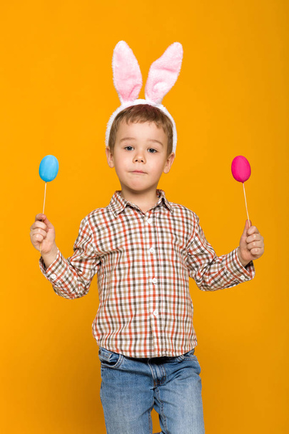 little child boy with Easter bunny ears holding colorful eggs - Photo, image