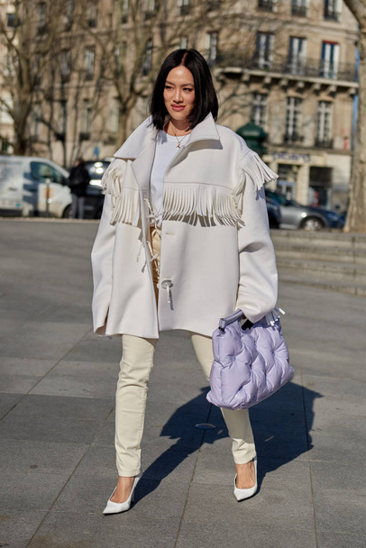 A trendy woman in fashionable outfit is pictured on the street during the Paris Fashion Week Fall/Winter 2019/2020 in Paris, France. - Fotó, kép