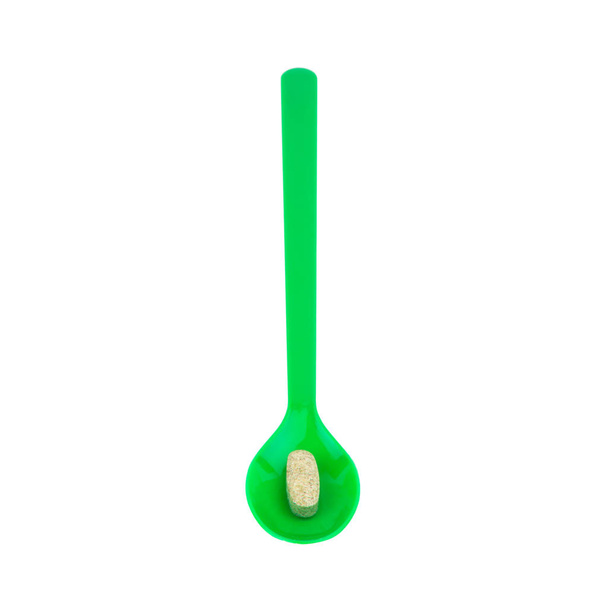 green spoon plastic with supplementary garlic  isolated on white - Photo, Image