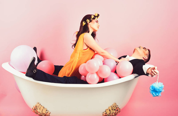 Conditioning your hair well. Couple of mime man and sexy woman enjoy bathing. Bubble bath day. Beauty routine and personal hygiene. Hair grooming routine. Bathing hygiene habits. Couple in bath tub - Photo, image