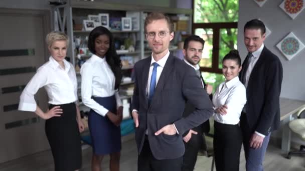 Confident businessman standing in front of his successful team - Footage, Video