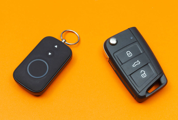 Car key with remote alarm control on the orange background - Photo, Image