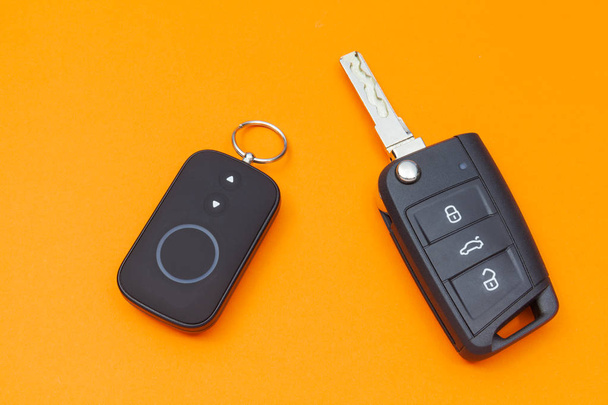 Opened Car Key with Remote Control on an orange background, top view - Photo, Image