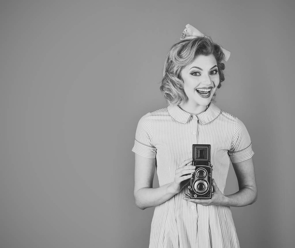 Photo of beautiful pin-up girl with old camera - Valokuva, kuva