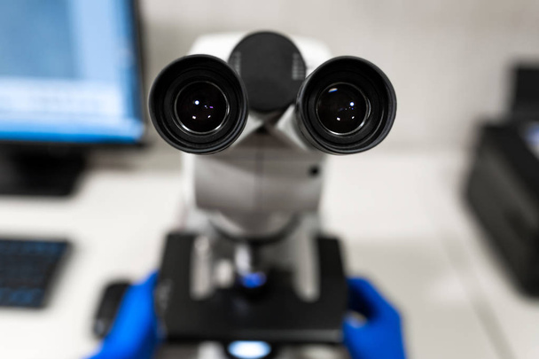 Closeup point of view of laboratory assistant looking through mi - Φωτογραφία, εικόνα