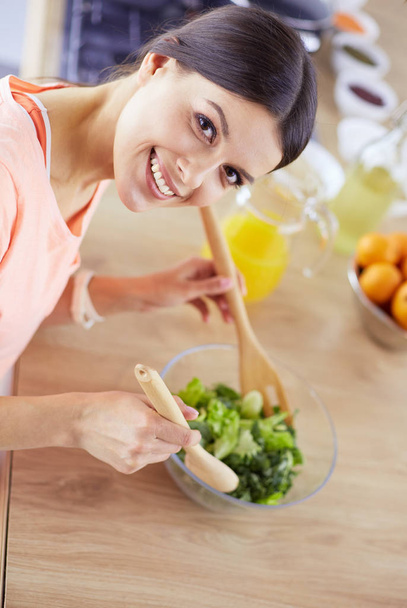 Young woman in the kitchen preparing a food - Photo, Image
