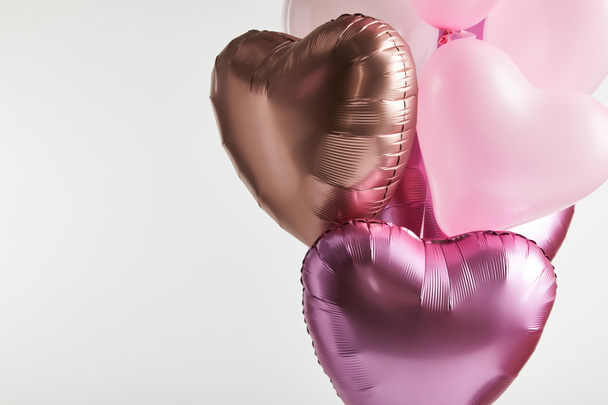 bundle of heart-shaped pink and golden balloons isolated on white with copy space - Foto, Bild