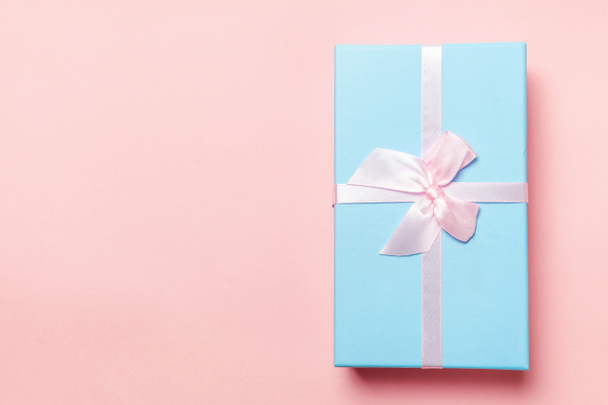 Christmas New Year birthday valentine celebration present romantic concept. Blue gift box isolated on pink background - Photo, Image