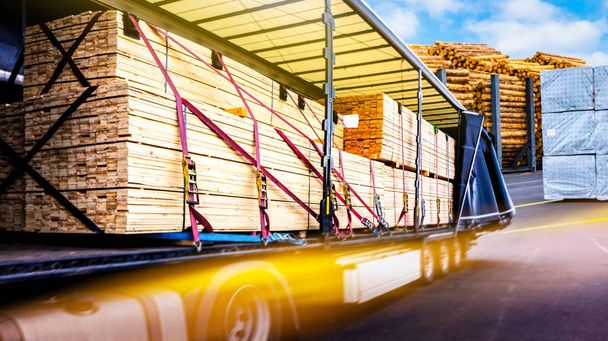There is a loading to the truck trailer . fastening of freight in the trailer . Truck in unloading in warehouse . Truck on the road . Commercial transport . truck transport container - Fotografie, Obrázek