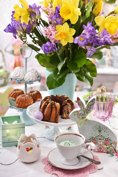 easter table decoration with traditional pastries and flowers - Fotó, kép