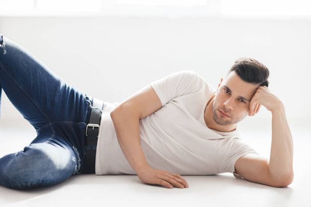 Sexy handsome young man lying on floor  - Foto, immagini