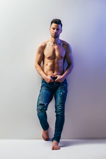 Full length portrait of sexy muscular shirtless man posing in studio. Male beauty - Photo, Image