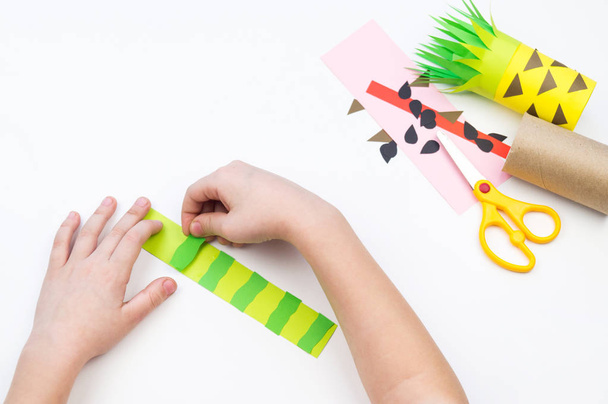 Child does the handicraft. Fruit paper. Pineapple and Watermelon summer. - Фото, изображение