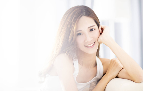 Young beautiful relaxed woman sitting on sofa - Photo, Image
