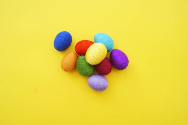 Easter eggs knitted from wool. Manual work. Rainbow. Easter. - 写真・画像
