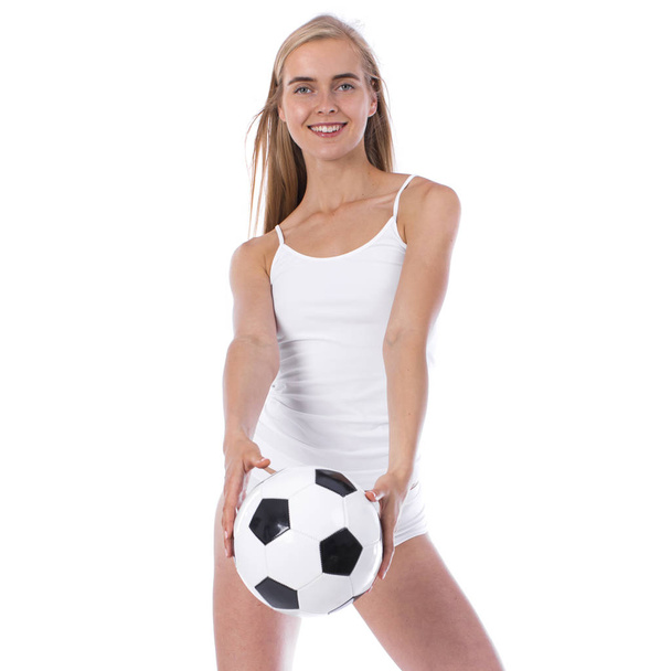 Young beautiful woman in white fitness clothing and soccer ball - Photo, Image