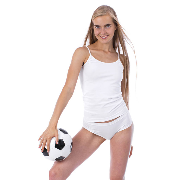 Young beautiful woman in white fitness clothing and soccer ball - Valokuva, kuva