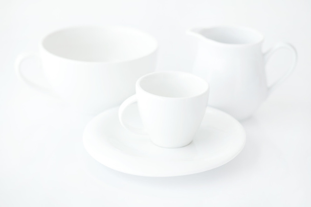 white cup with saucer and milk jug - Foto, afbeelding
