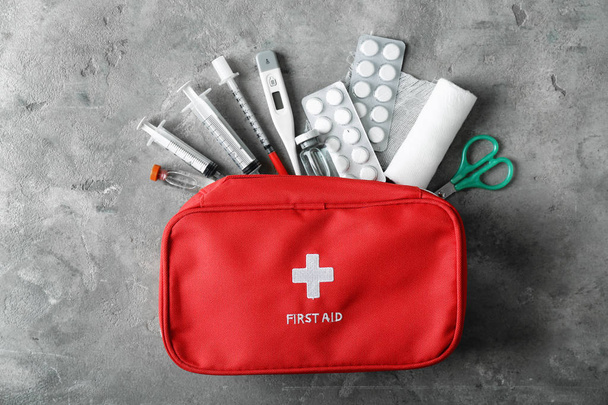 First aid kit on grunge background - Φωτογραφία, εικόνα