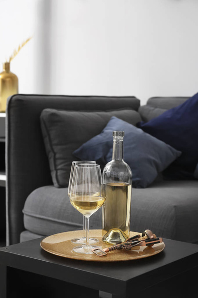 Bottle and glasses of champagne on table in modern room - Foto, imagen