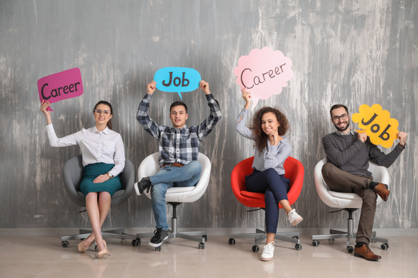 Young people holding speech bubbles with words JOB and CAREER indoors - Φωτογραφία, εικόνα