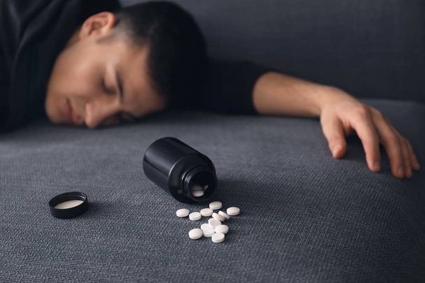 Unconscious man after taking drugs. Suicide awareness concept - Photo, Image