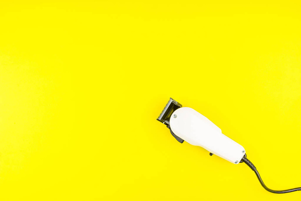 White electric clippers barber on yellow background. Hairdresser - Fotografie, Obrázek