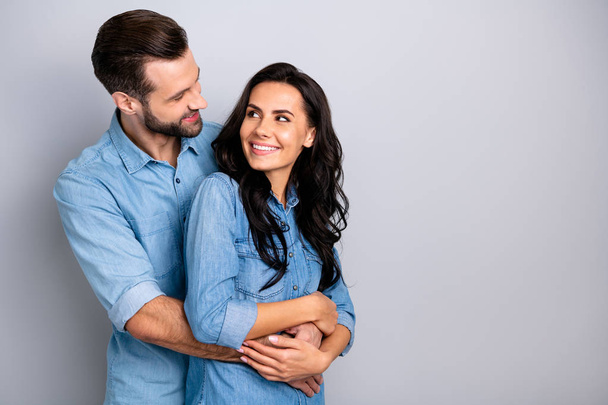 Portrait of cute casual beautiful cozy spouses cheerful soulmates pregnancy bonding delighted fooling joking laughing waiting for baby isolated wearing denim clothes on ashy-grey background - Photo, Image