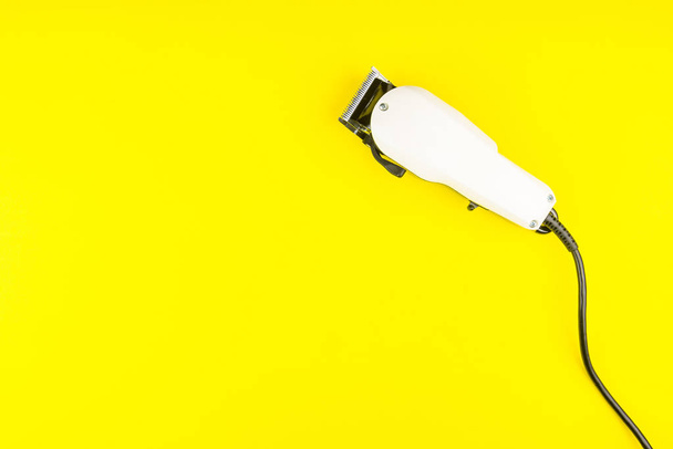 White electric clippers barber on yellow background. Hairdresser - Valokuva, kuva