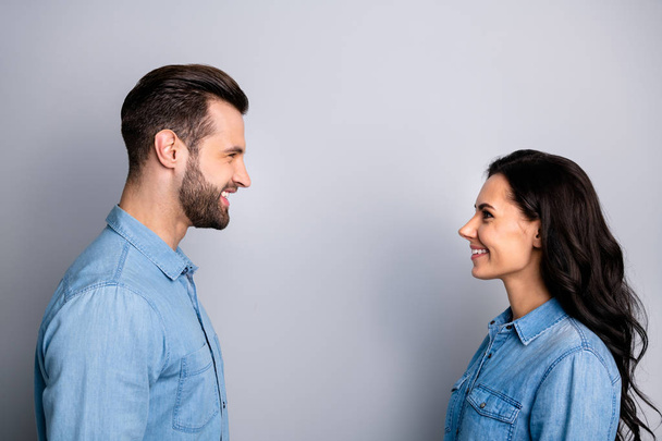 Lets talk. Profile side photo of cute positive beautiful students fellows staring speaking telling greeting having dialogue dressed in denim clothing isolated on argent background  - Zdjęcie, obraz