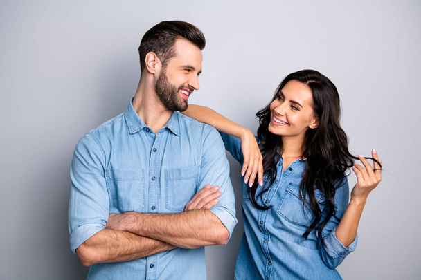 Portrait of cute pleasant adorable guy lady trying to go on date touching shoulder curls by hand fingers looking tender gentle wearing denim outfit on argent background - Foto, afbeelding