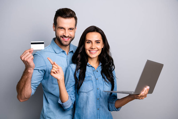 Close up photo beautiful amazing she her he him his couple lady guy hold credit card notebook show simple way internet buy pay  wear casual jeans denim shirts outfit clothes isolated grey background - Fotoğraf, Görsel