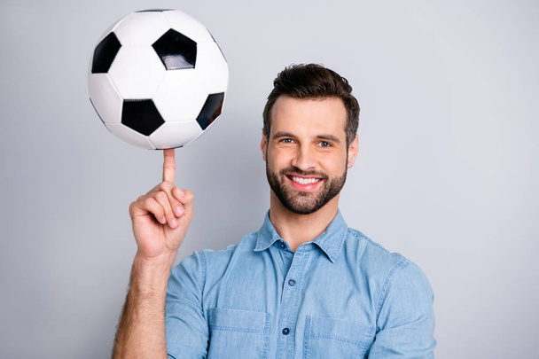 Close up photo amazing macho he him his guy show hand arm finger hold football leather ball round moves show cool tricks wear casual jeans denim shirts outfit clothes isolated light grey background - Фото, зображення
