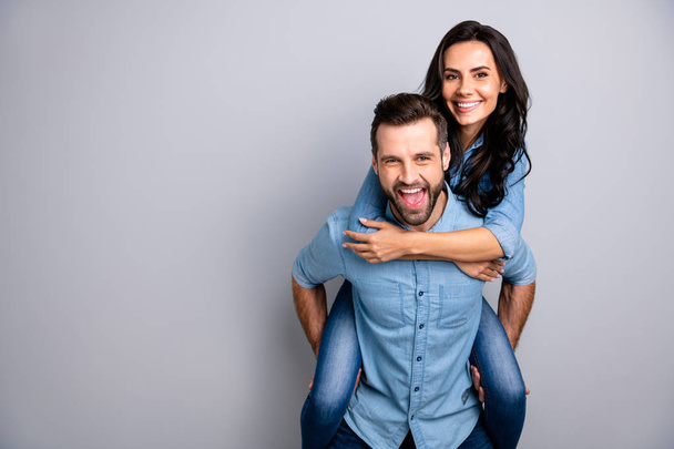 Close up photo funky amazing cheer she her he him his couple lady guy best friends piggyback ride buddies ready party wear casual jeans denim shirts outfit clothes isolated light grey background - Fotó, kép