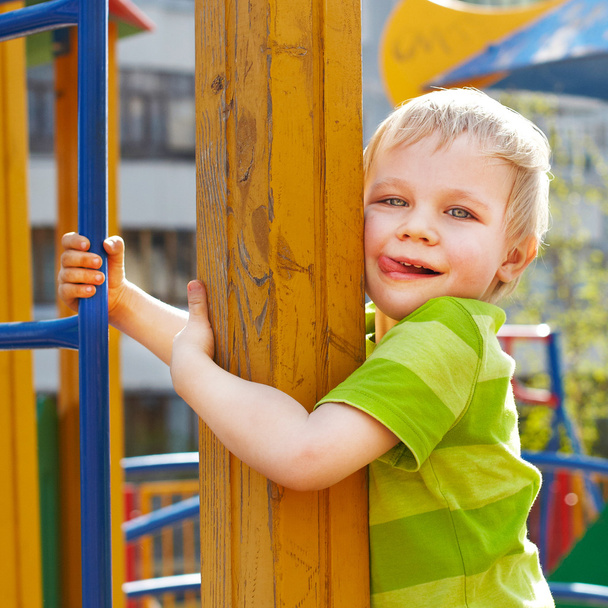 Little boy is playing on playground - Φωτογραφία, εικόνα
