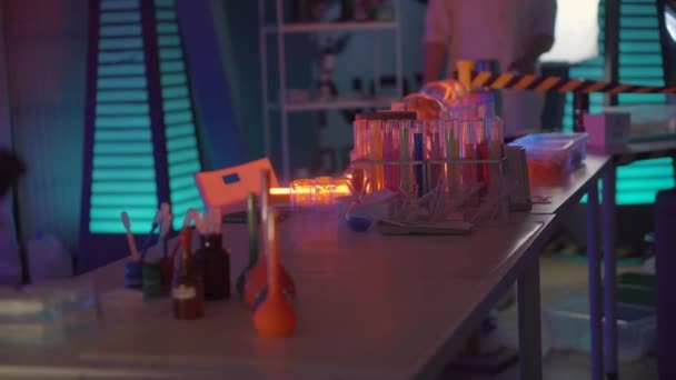 Table in secret chemical laboratory, vials with different colors liquids - Footage, Video