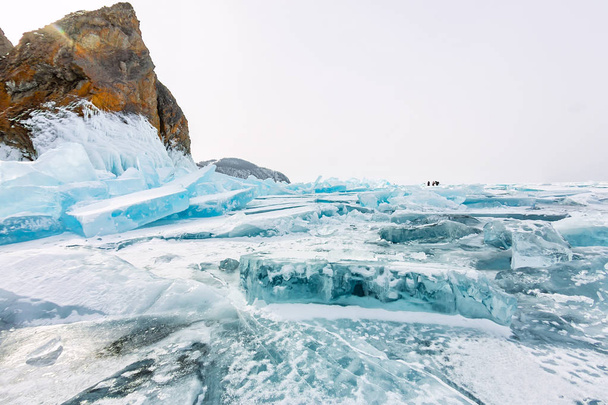 Cape Khoboy rock on Olkhon Island, Lake Baikal, ice hummocks in winter, Russia, Siberia - Photo, image
