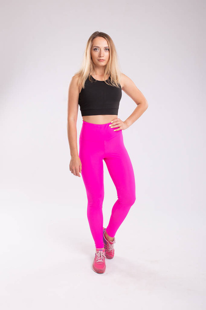 Female sport concept. Sporty woman wearing pink leggings. - 写真・画像