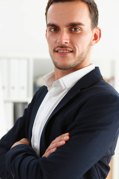 Handsome smiling man in suit stand in office - Fotó, kép