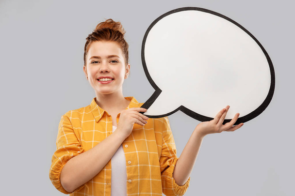 red haired teenage girl holding speech bubble - 写真・画像